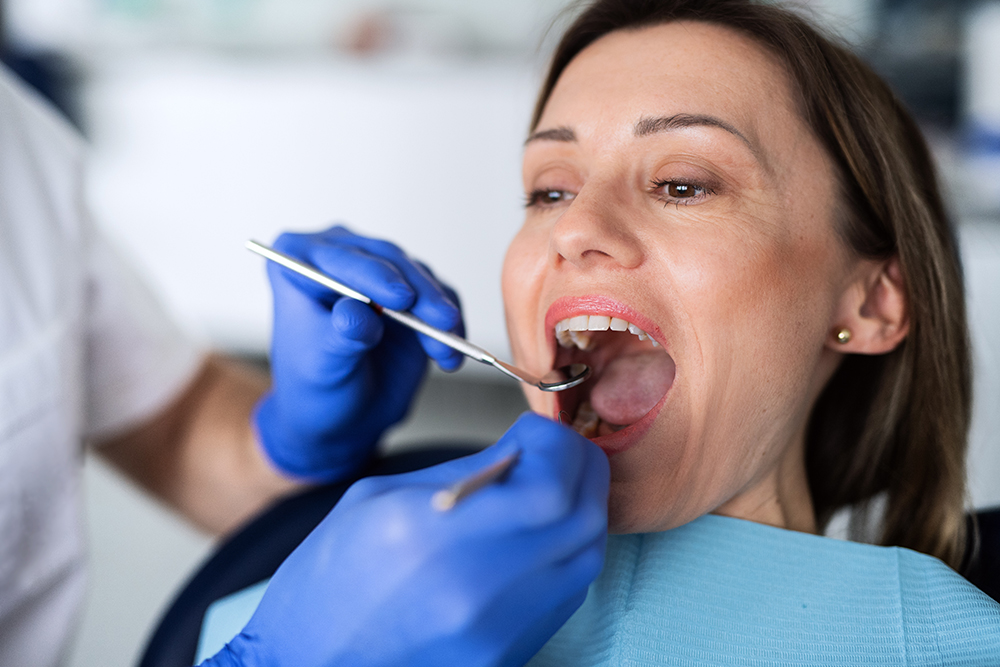 A woman has a dental check-up in dentist surgery.
